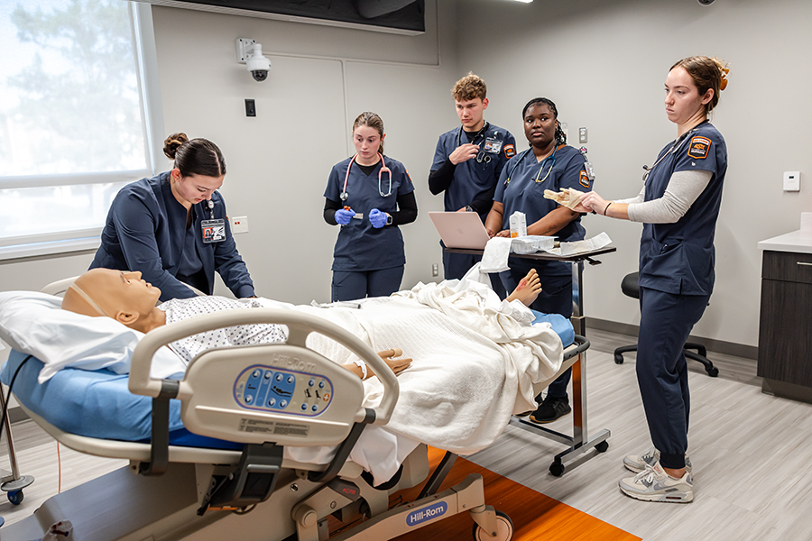 Nursing students and instructors in the sim lab