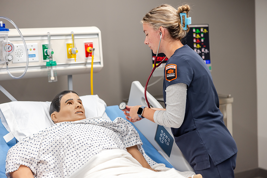 Nursing student with lab dummy
