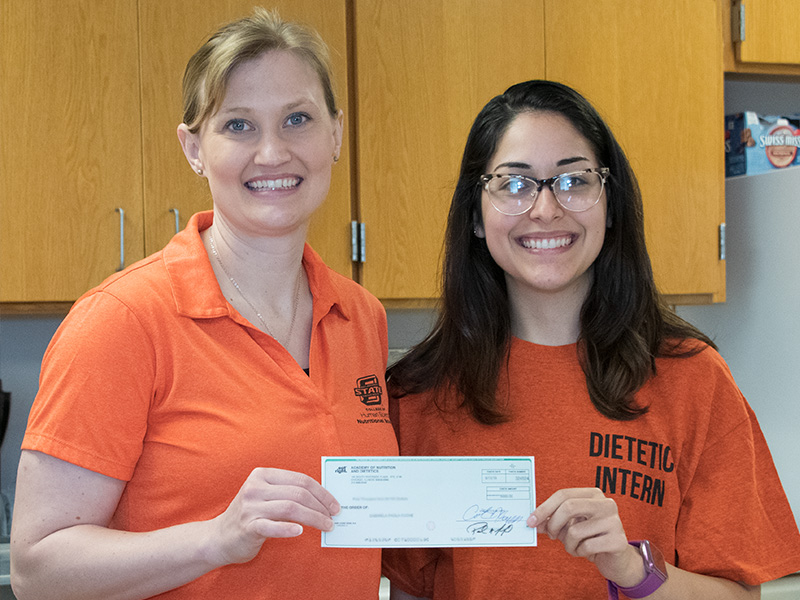 Student with scholarship check