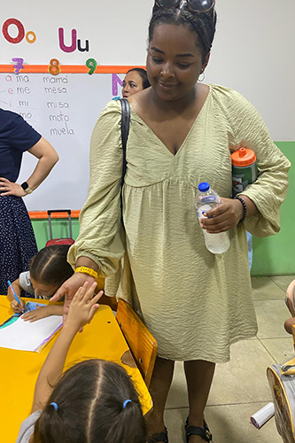 Lydia Solomon in a classroom with students in Columbia
