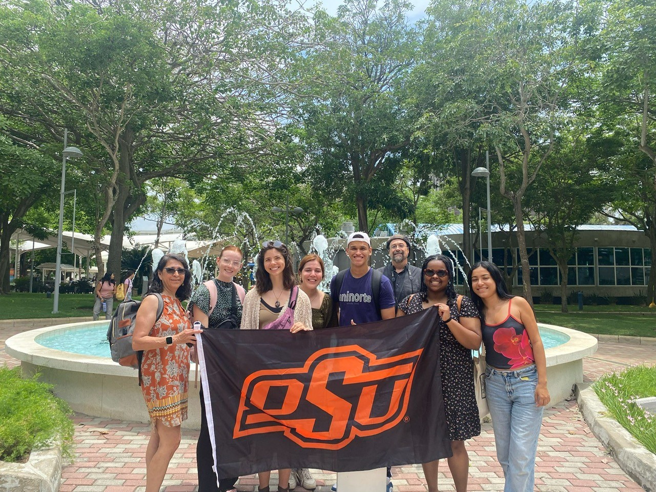 Students and faculty holding an OSU flag in Columbia