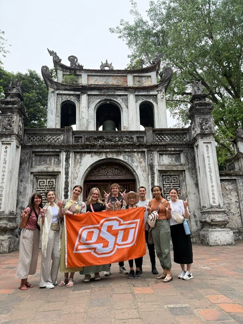 Students holding an OSU flag in Vietnam