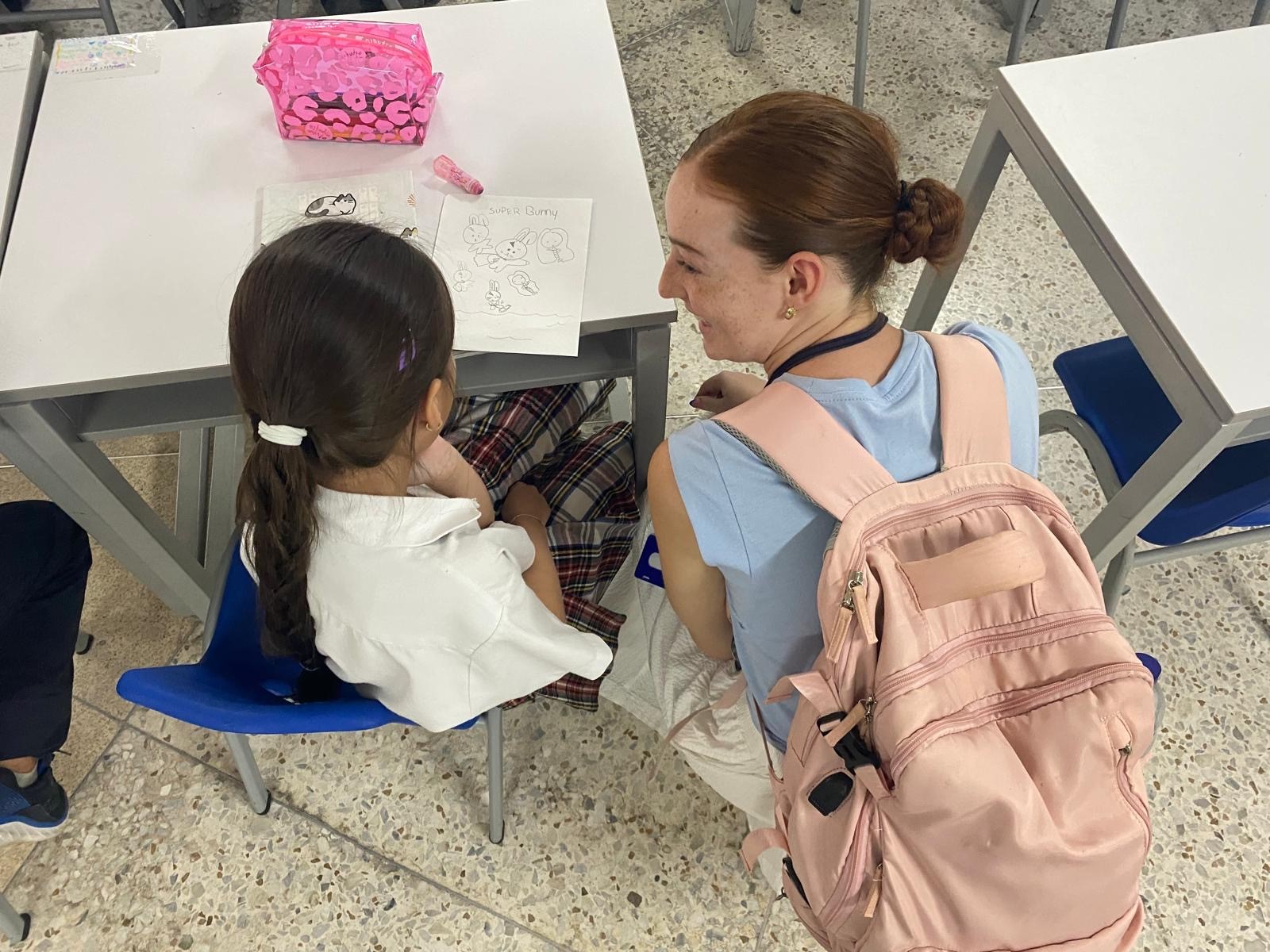 Students in the classroom in Columbia with a student